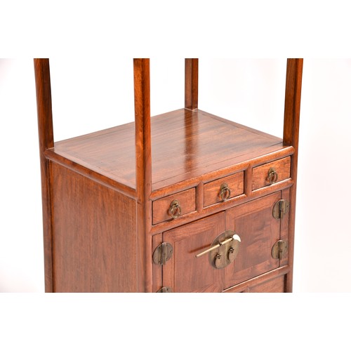 50 - A large Chinese hardwood three tier whatnot, each level inset with three small drawers, the base wit... 