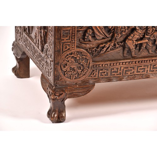 51 - A large Chinese carved camphor wood chest, elaborately carved all over with soldiers and horses trav... 