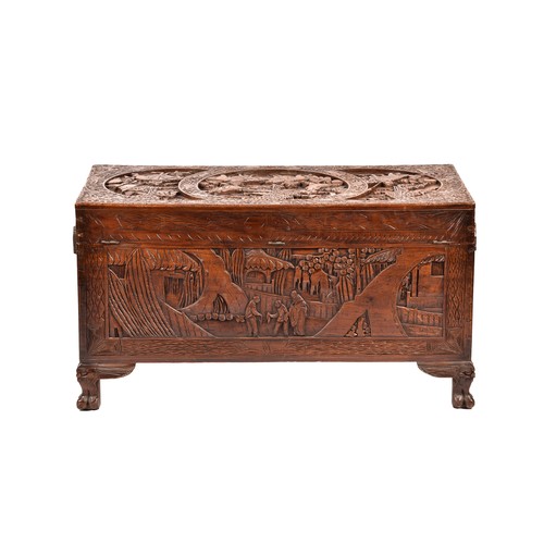 51 - A large Chinese carved camphor wood chest, elaborately carved all over with soldiers and horses trav... 