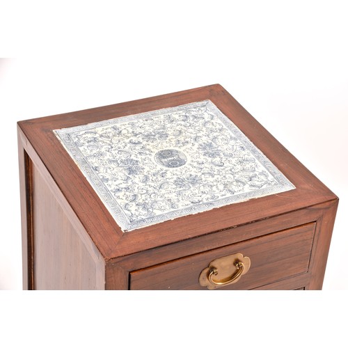 52 - the top with inset Chinese blue and white tile decorated with flowers and leaves, over a single draw... 