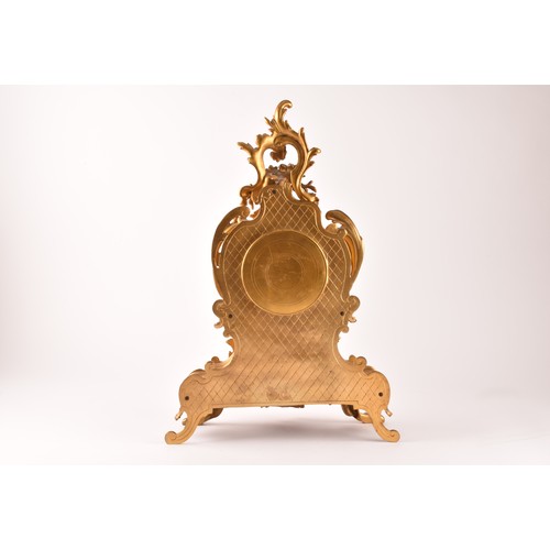 253 - An antique French gilt bronze Rococo style clock garniture, the mantel clock of waisted keyhole shap... 