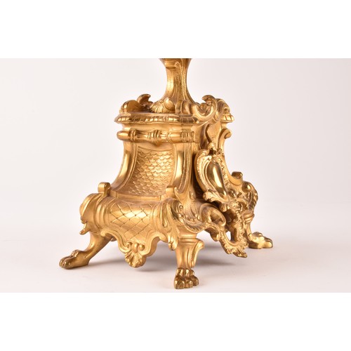 253 - An antique French gilt bronze Rococo style clock garniture, the mantel clock of waisted keyhole shap... 