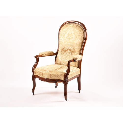 284 - A Victorian mahogany library spoonback armchair, with carved and scrolled open arms, show wood frame... 