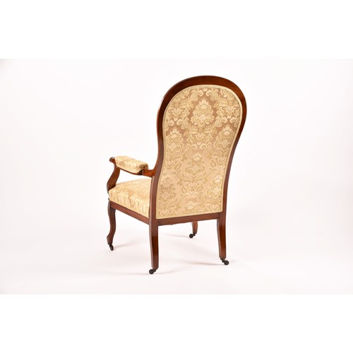 284 - A Victorian mahogany library spoonback armchair, with carved and scrolled open arms, show wood frame... 