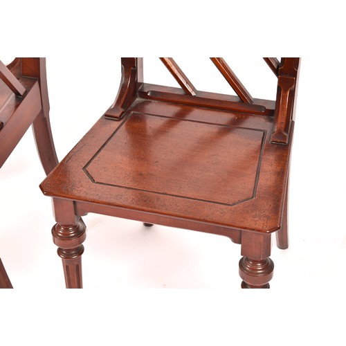 285 - A pair of Victorian mahogany Gothic style hall chairs, the backs with diagonal rails and turned fini... 