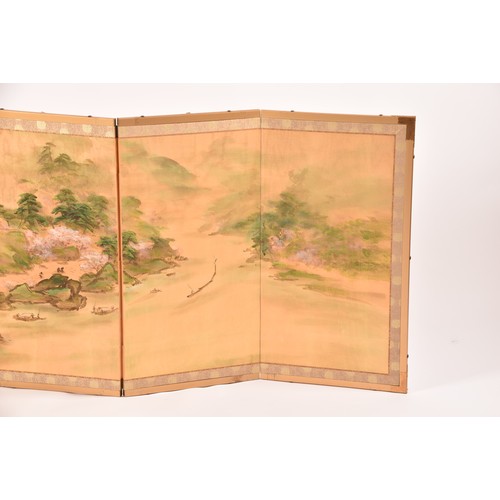 53 - A Japanese silk table top or wall hanging four fold screen, painted with an extensive landscape scen... 