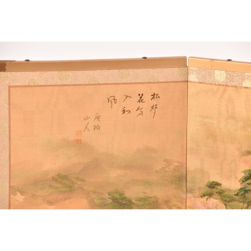 53 - A Japanese silk table top or wall hanging four fold screen, painted with an extensive landscape scen... 