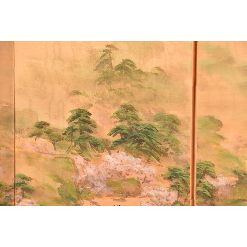 53 - A Japanese silk table top or wall hanging four fold screen, painted with an extensive landscape scen... 