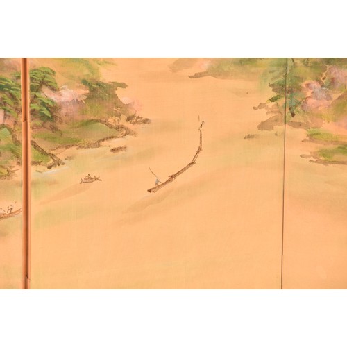 53 - A Japanese silk table top or wall hanging four fold screen, painted with an extensive landscape scen... 