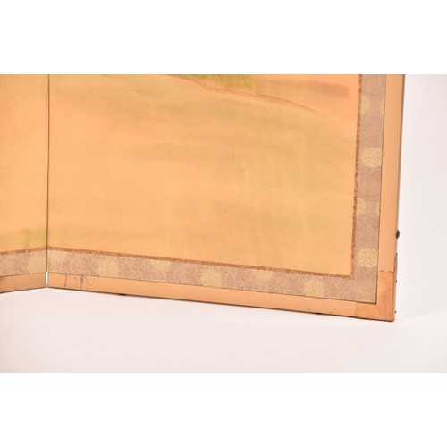 53 - A Japanese silk table top or wall hanging four fold screen, painted with an extensive landscape scen... 