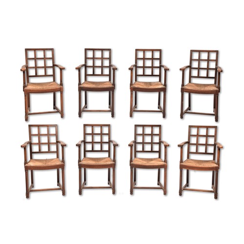 286 - A set of eight Cotswold School Arts & Crafts oak lattice back armchairs, c.1920, with shaped arm... 