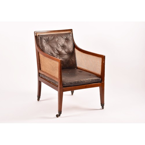 288 - A 19th century mahogany bergere armchair, with mahogany show wood reeded frame, with cane back and s... 