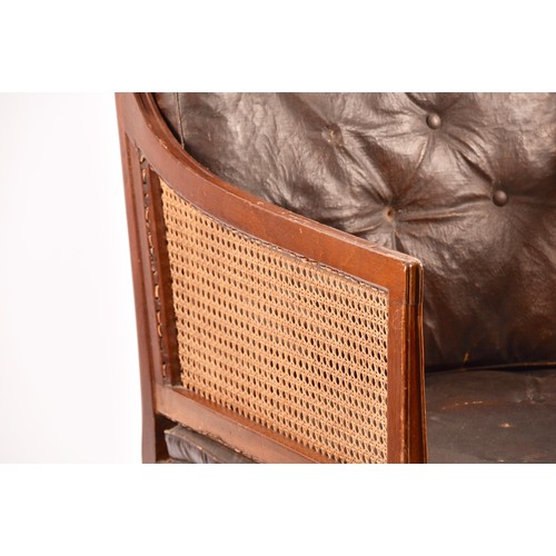 288 - A 19th century mahogany bergere armchair, with mahogany show wood reeded frame, with cane back and s... 