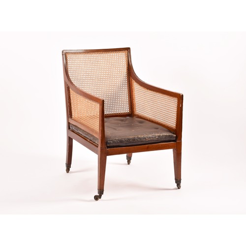 288 - A 19th century mahogany bergere armchair, with mahogany show wood reeded frame, with cane back and s... 