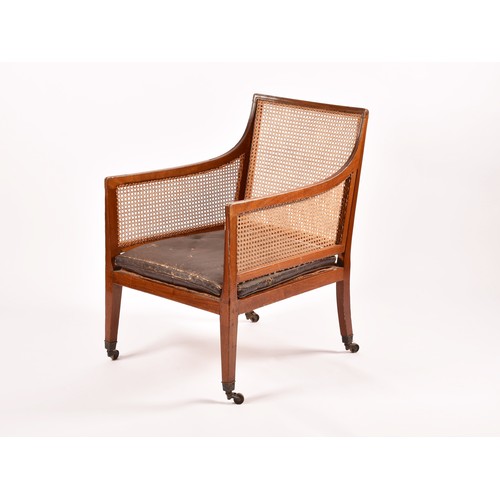 288 - A 19th century mahogany bergere armchair, with mahogany show wood reeded frame, with cane back and s... 