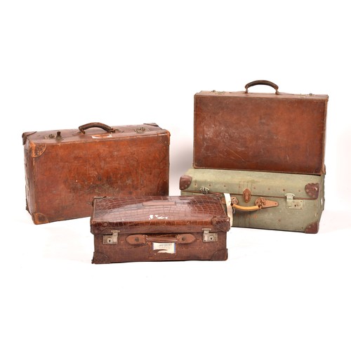 248 - A group of two leather, one alligator skin and one canvas covered suitcases / trunks, the canvas cov... 