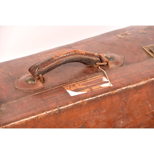 248 - A group of two leather, one alligator skin and one canvas covered suitcases / trunks, the canvas cov... 