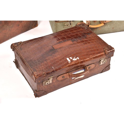 248 - A group of two leather, one alligator skin and one canvas covered suitcases / trunks, the canvas cov... 