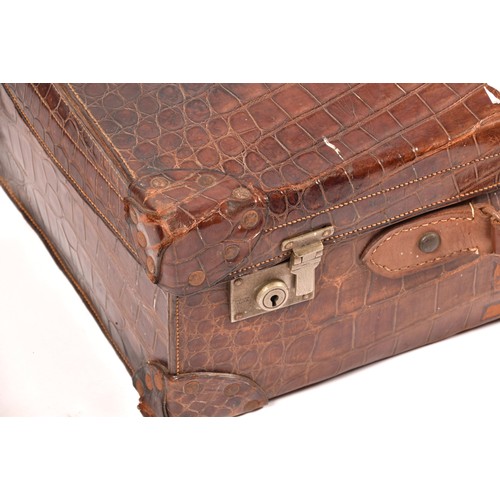 248 - A group of two leather, one alligator skin and one canvas covered suitcases / trunks, the canvas cov... 