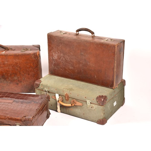 248 - A group of two leather, one alligator skin and one canvas covered suitcases / trunks, the canvas cov... 