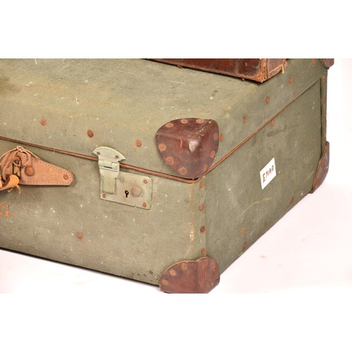 248 - A group of two leather, one alligator skin and one canvas covered suitcases / trunks, the canvas cov... 