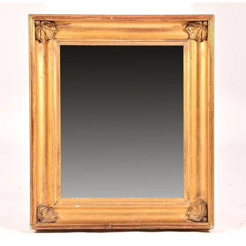 292 - A 19th century gilt framed rectangular wall mirror, the gilt gesso frame with shell mounted corners.... 