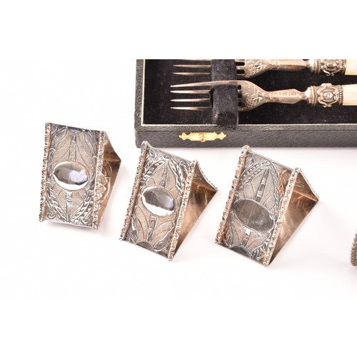 201 - A group of silver items to include a pair of candlesticks, a group of napkin rings, a boxed set of s... 