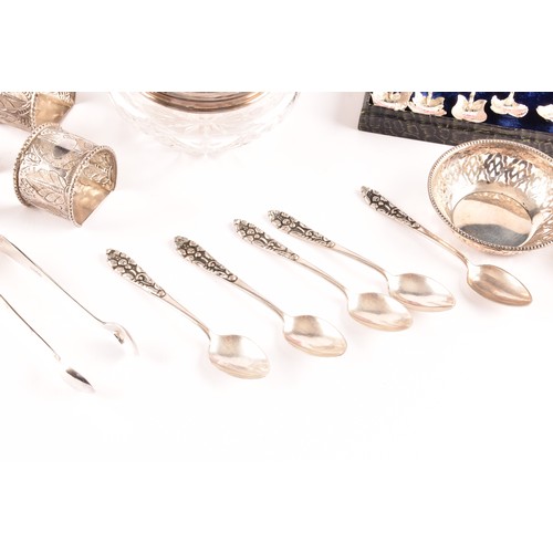 201 - A group of silver items to include a pair of candlesticks, a group of napkin rings, a boxed set of s... 