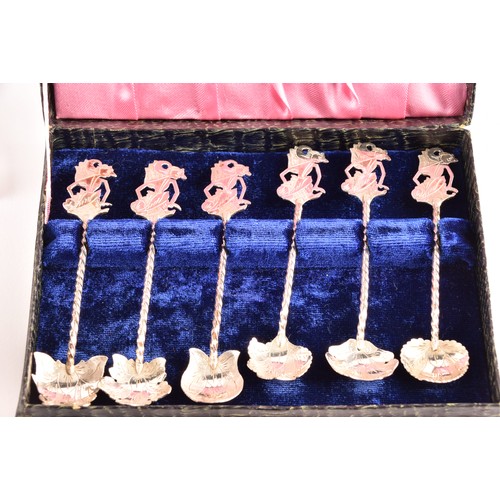 201 - A group of silver items to include a pair of candlesticks, a group of napkin rings, a boxed set of s... 