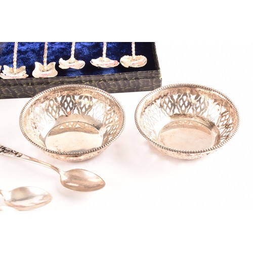 201 - A group of silver items to include a pair of candlesticks, a group of napkin rings, a boxed set of s... 