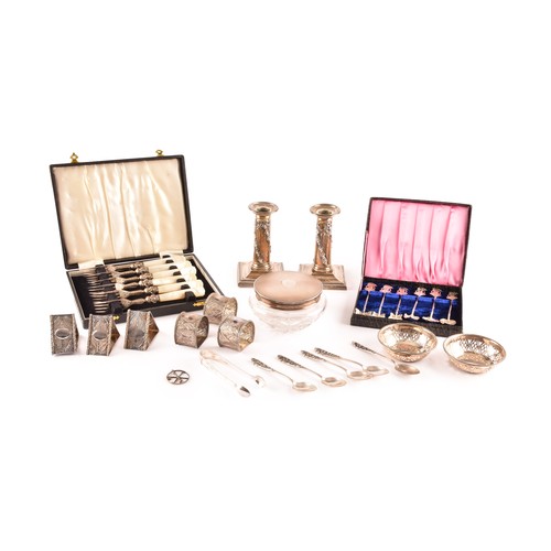 201 - A group of silver items to include a pair of candlesticks, a group of napkin rings, a boxed set of s... 