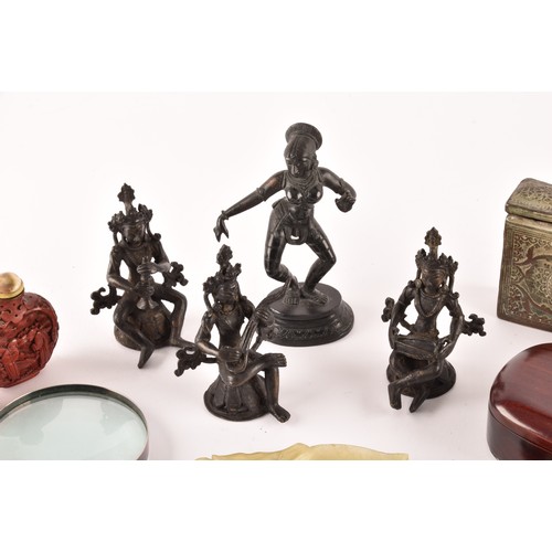 57 - A group of Asian Objet d'art, including a set of three Nepalese bronze figures, an Indian figure of ... 