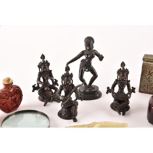 57 - A group of Asian Objet d'art, including a set of three Nepalese bronze figures, an Indian figure of ... 