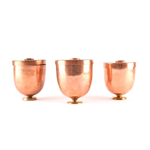 249 - A group of three Victorian copper jelly moulds with lids, each 12 x 10.5cm.