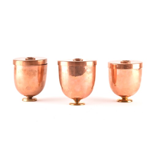 249 - A group of three Victorian copper jelly moulds with lids, each 12 x 10.5cm.