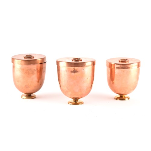 249 - A group of three Victorian copper jelly moulds with lids, each 12 x 10.5cm.