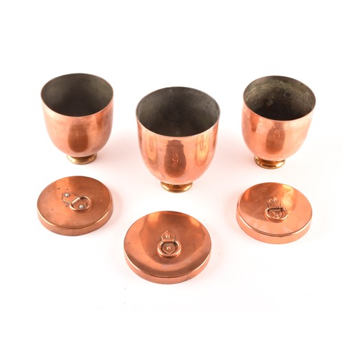 249 - A group of three Victorian copper jelly moulds with lids, each 12 x 10.5cm.