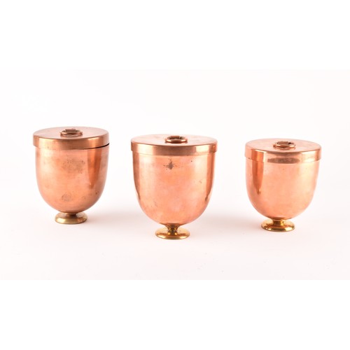 249 - A group of three Victorian copper jelly moulds with lids, each 12 x 10.5cm.