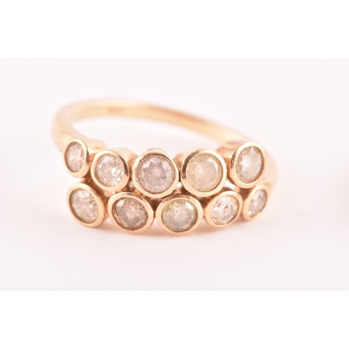 110 - A 9ct yellow gold and diamond crossover style ring, collet-set with ten round brilliant-cut diamonds... 