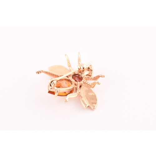 111 - A 9ct yellow gold brooch in the form of an insect, set with a garnet and citrine, having textured wi... 