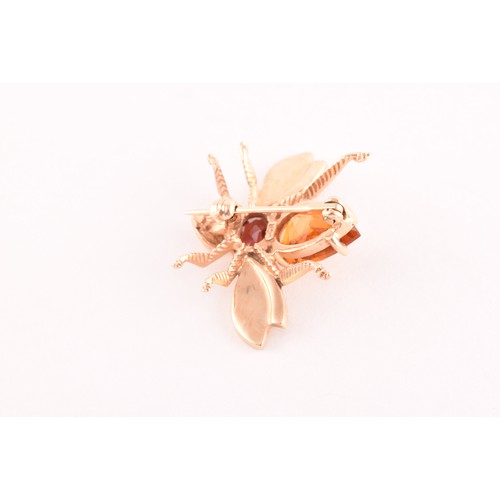 111 - A 9ct yellow gold brooch in the form of an insect, set with a garnet and citrine, having textured wi... 