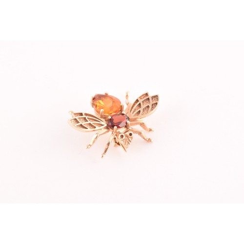 111 - A 9ct yellow gold brooch in the form of an insect, set with a garnet and citrine, having textured wi... 