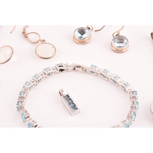 113 - A silver, blue and white topaz line bracelet, together with a silver chain suspended with four silve... 