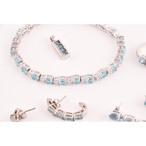 113 - A silver, blue and white topaz line bracelet, together with a silver chain suspended with four silve... 