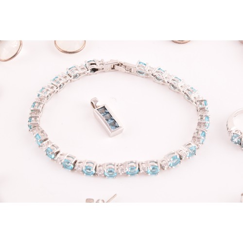 113 - A silver, blue and white topaz line bracelet, together with a silver chain suspended with four silve... 