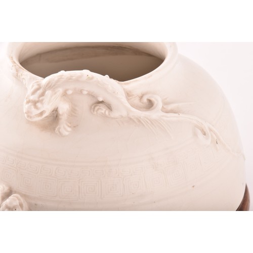 15 - A Chinese blanc de chine low vase, the rim crested with a dragon in relief, with a band of impressed... 