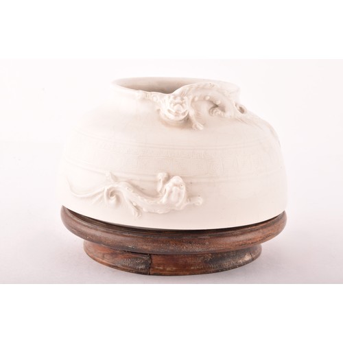 15 - A Chinese blanc de chine low vase, the rim crested with a dragon in relief, with a band of impressed... 