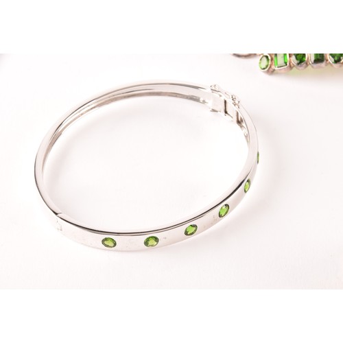 124 - A silver and chrome diopside bracelet, the central segment collet-set with mixed-cut stones, on chai... 