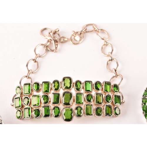 124 - A silver and chrome diopside bracelet, the central segment collet-set with mixed-cut stones, on chai... 