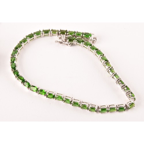 124 - A silver and chrome diopside bracelet, the central segment collet-set with mixed-cut stones, on chai... 